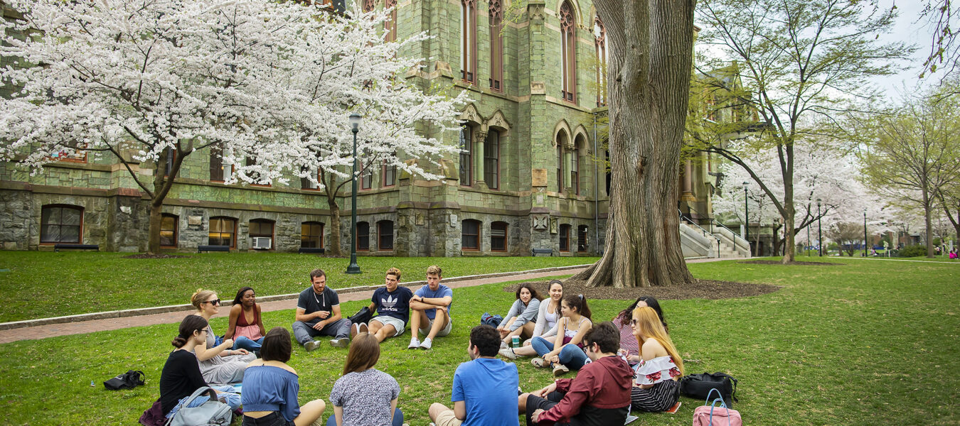 Students sit in circle on Penn campus.