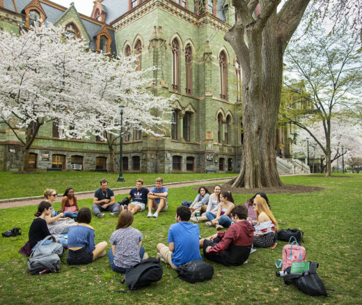 Students sit in circle on Penn campus.