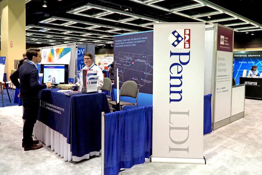 Wharton Health Care Management PhD student Benjamin Chartock mans the LDI booth at the 2018 AcademyHealth Annual Research Meeting