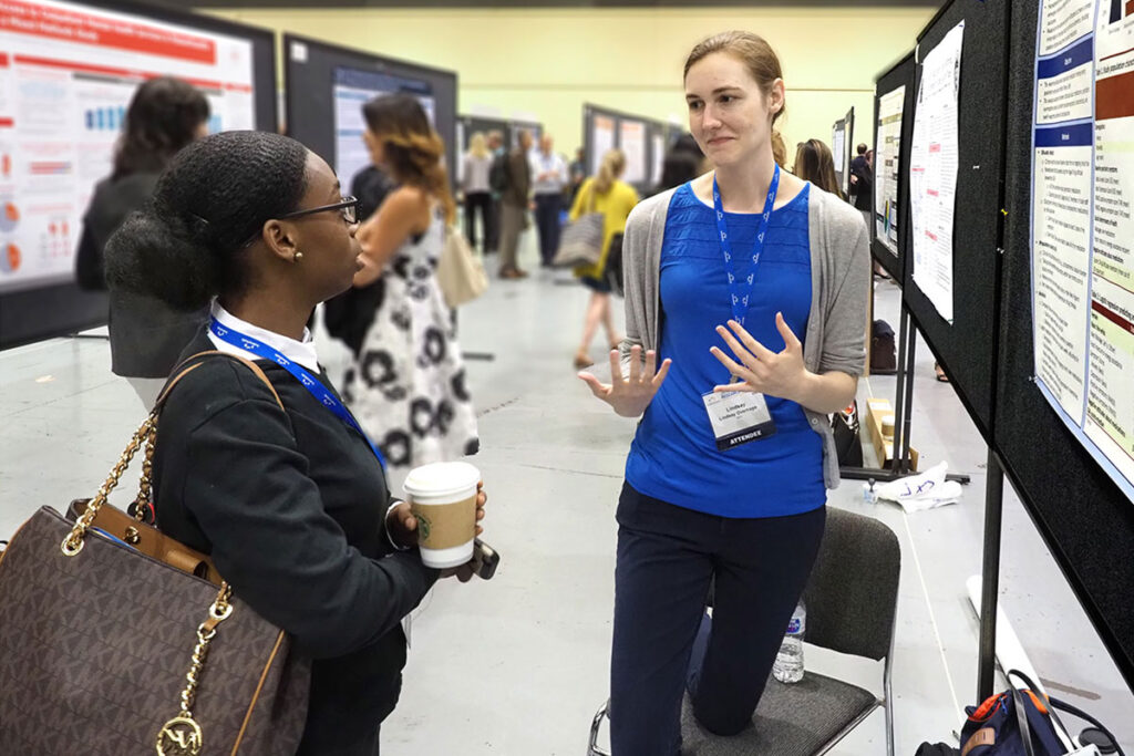 Janiece Strange of Morgan State University chats with Lindsay Overhage, a Health Policy Research Assistant at Massachusetts General Hospital