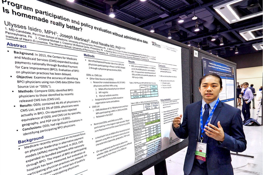 Penn Perelman School of Medicine student Ulysses (Ace) Isidro with a scientific poster