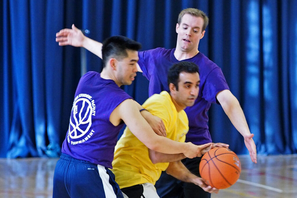 Julius Chen, Henry Bergquist, and Amol Navathe battle for the basketball