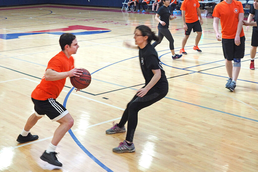 PhD student Evan Saltzman confronts LDI Assistant Director of Health Policy Rebecka Rosenquist (above, right) who ultimately knocks the ball loose