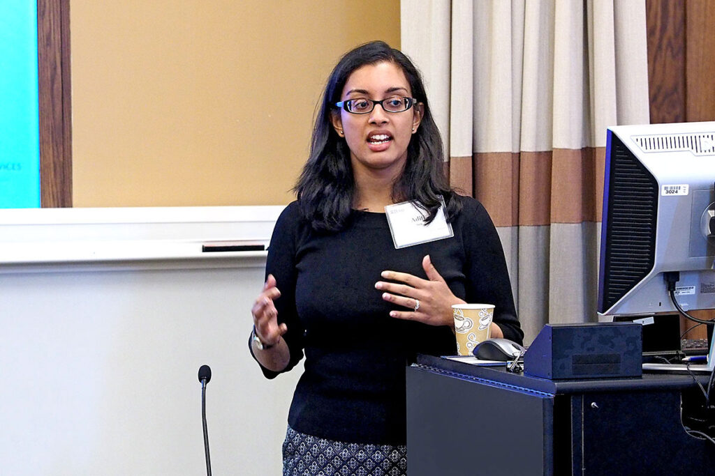 Aditi Sen, PhD at the podium  at a scientific conference