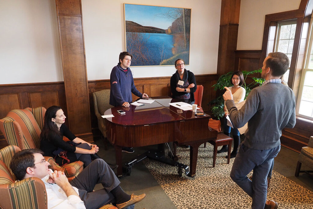 In a piano alcove at Skytop Lodge, LDI Senior Fellow Chen Kenyon, MD, MSHP, Penn Assistant Professor of Pediatrics pitches an idea to members (l to r) George Anesi, MD, MBE, Postdoctoral Fellow, Perelman School of Medicine; Vanessa Madden, , BSc Hons, Project Manager, FIELDS program; Alexander Morris, BS, Clinical Research Coordinator at the Perelman School of Medicine; Pamela Shaw, PhD, Penn Associate Professor of Biostatistics; and Erin Huang, a CHIBE Data Analyst.