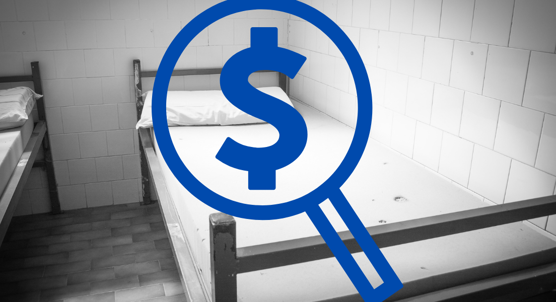 Blue magnifying glass with dollar sign inside over a black and white photo of a bed.