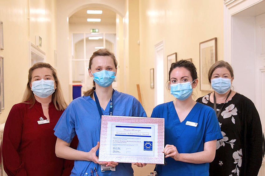 Staffers in St. James's Hospital in Dublin, Ireland display their milestone achievement award