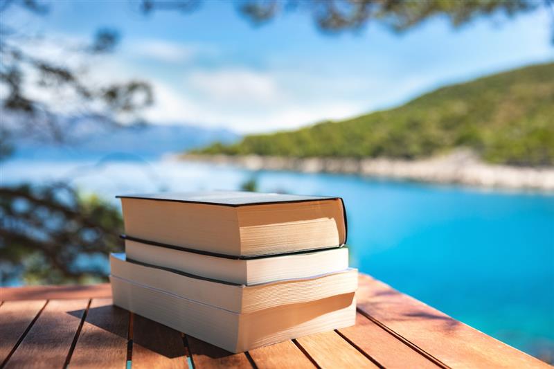 Stack of books at the ocean.