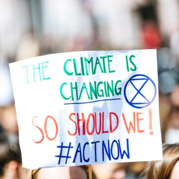 A person holding up a climate change sign