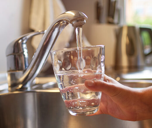 Someone pouring a glass of water