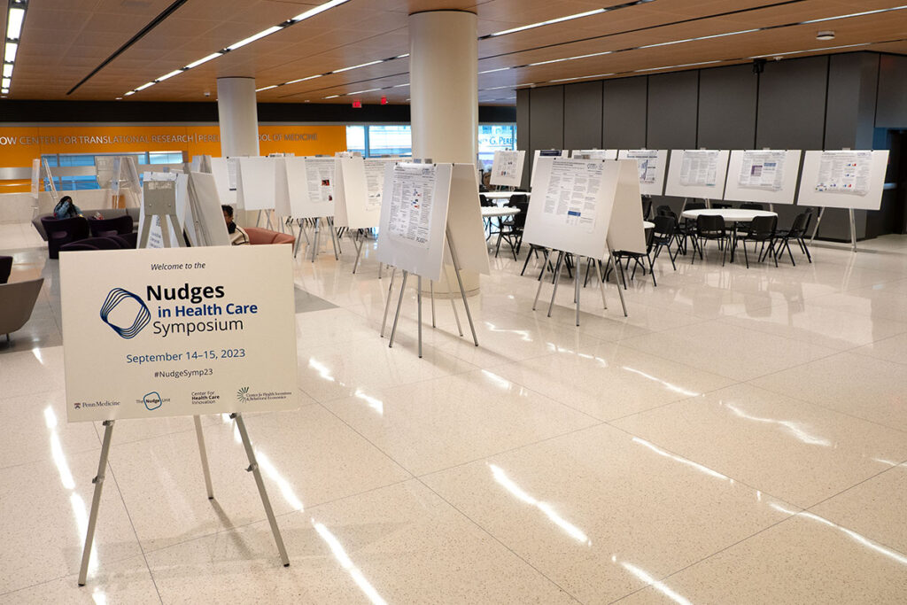 Preparing poster displays at the 2023 Nudges in Health Care Symposium.